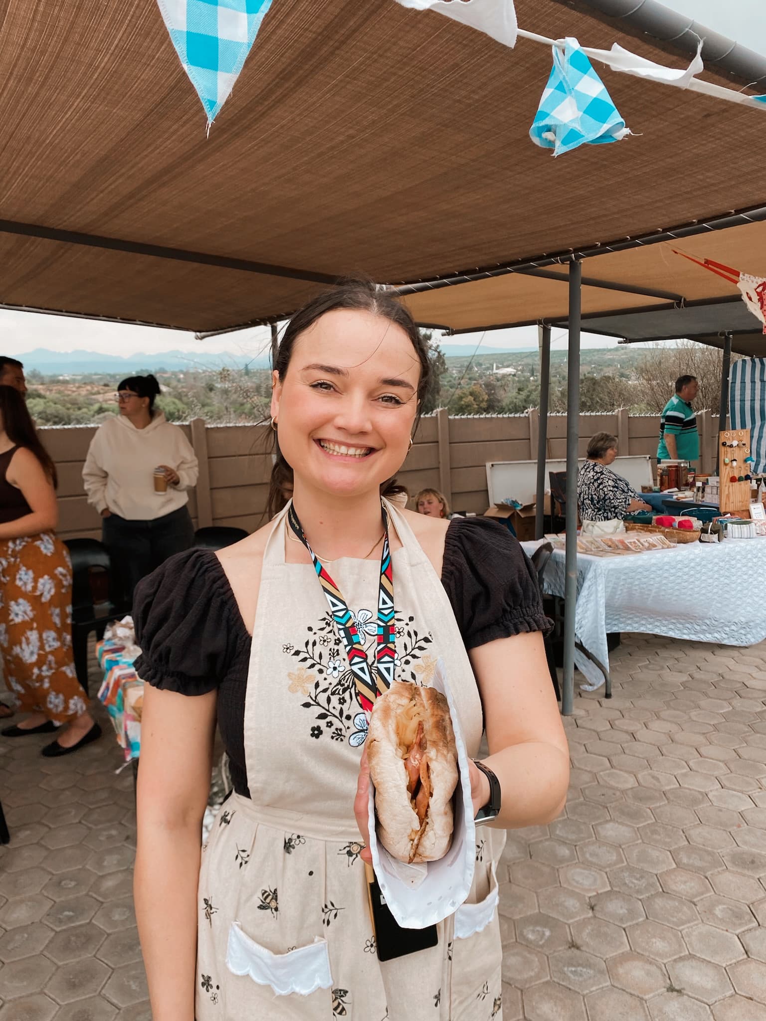 A smiling food vendor at the market